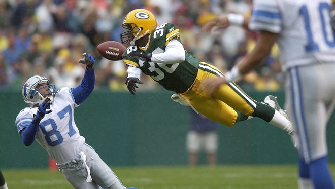 Green Bay Packers Leroy Butler knocks the ball away from Lions receiver Johnnie Morton during a game at Lambeau Field on Sept. 9, 2001.