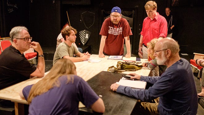 Jack Bathke (third from left, in blue cap) rehearses a scene from the production of Shakespeare’s “Henry V” that he is directing for Circle Players of Piscataway. The ensemble cast includes (clockwise from left) Phil Bramson, Daniel Nugent, Bathke (who is also playing the Chorus), Andrew James Gordon (who plays Henry V), Mike Johnson, Ruth Learn, Fred Dennehy, and Tess Ammerman (who is also assistant director).
