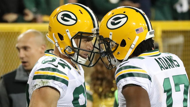 Green Bay Packers wide receiver Jordy Nelson (87) gets a helmet bump from wide receiver Davante Adams (17) after a long reception Thursday, September 28, 2017 against the Chicago Bears at Lambeau Field in Green Bay, Wis.