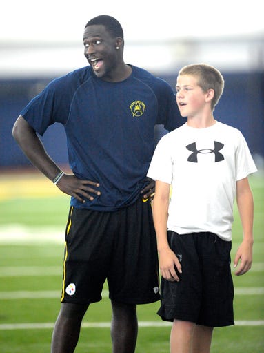 Devin Gardner laughs as he coaches players.