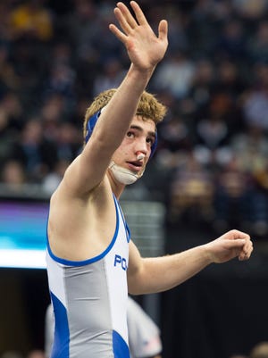 Jacob Greenwood of Poudre High School waves to fans in the crowd after defeating Cole Polluconi of Monarch during the CHSAA state wrestling tournament at the Pepsi Center in Denver Saturday. Greenwood walked away with his second state title.