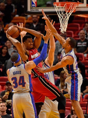 Pistons guard Avery Bradley, right, and forward Tobias Harris defend Heat center Hassan Whiteside in the first half at American Airlines Arena on Wednesday, Jan. 3, 2018.