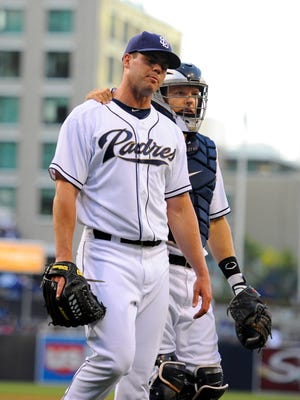 June 21, 2013; San Diego, CA, USA; San Diego Padres starting pitcher Clayton Richard (33) walks off the field with catcher Nick Hundley (4) with an injury after two pitches during the first inning against the Los Angeles Dodgers at Petco Park.  Mandatory Credit: Christopher Hanewinckel-USA TODAY Sports