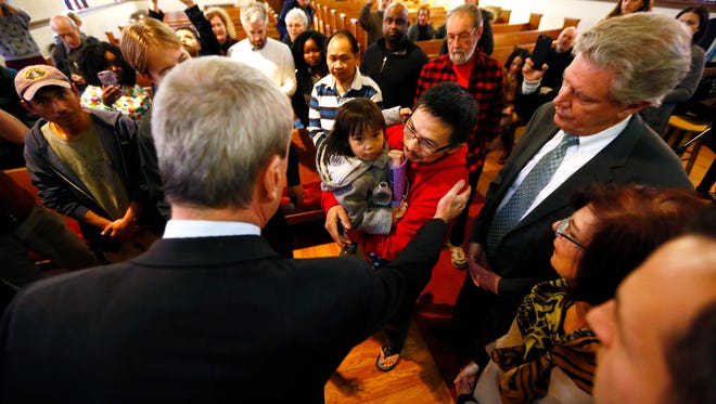Governor Phil Murphy comforts Yohanes Tasik and 3-year-old daughter Krystal as Congressman Frank Pallone Jr looks on at the Highland Park Reformed Church. January 25, 2018. Highland Park, NJ.