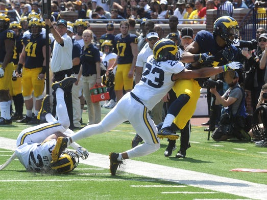 University of Michigan receiver Tarik Black is tackled