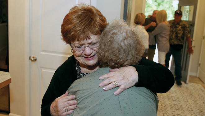 Beverly Meier from Sacramento, California, hugs sister Joyce Risher of Bremerton, who she met for the first time Thursday. Meier, who was adopted as a baby, took a DNA test for ancestry.com, which lead her down the path to finding her birth family.