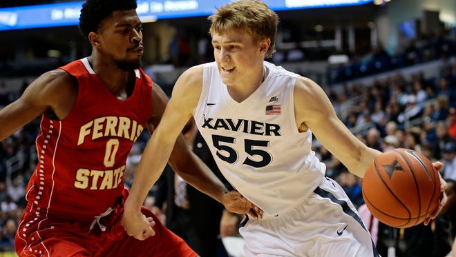 Xavier Musketeers guard J.P. Macura (55) drives along the baseline during the first half of NCAA exhibition game between the Xavier Musketeers and the Ferris State Bulldogs at the Cintas Center on the campus of Xavier University in Cincinnati, on Saturday, Nov. 5, 2016. After one half, Xavier led 35-23.