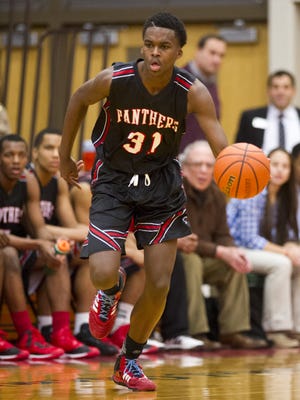North Central High School sophomore Kris Wilkes (31) brings the ball up court during the first half of action. Lawrence North High School hosted North Central High School in a first-round game of the 2015 Marion County Boys Basketball Tournament, Tuesday, Jan. 13, 2015.