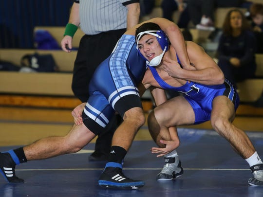 Hammonton’s Daniel Figueroa gets inside of Highland’s Nick Genna at 160 pounds during a 44-24 setback on Jan. 13.