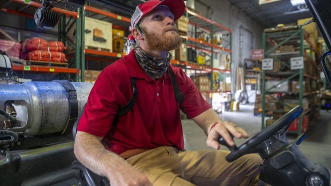 Ryan Hastings operates a forklift at Ram Tools in Austin on Friday. Hastings was planning to enroll in the Austin police academy this summer before the City Council canceled his class over concerns about the curriculum. He says he no longer plans to be a police officer.