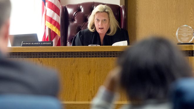 Juvenile Judge Karen Lawson tells an 11-year-old girl her rights at a detention hearing on Monday.