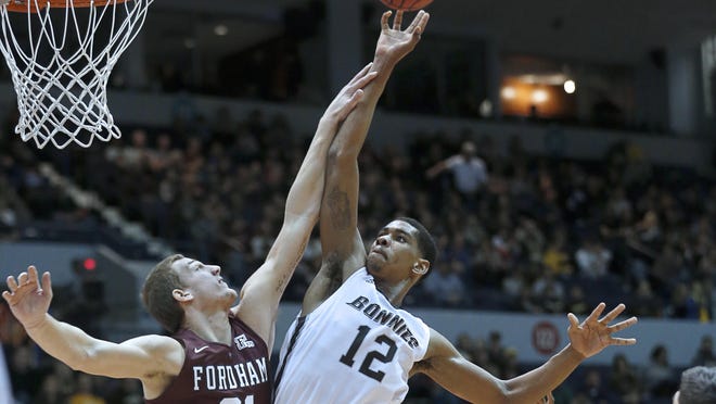 Fordham's Jesse Bunting sets up a block on St. Bonaventure's Denzel Gregg in the second half at the Blue Cross Arena at the War Memorial.