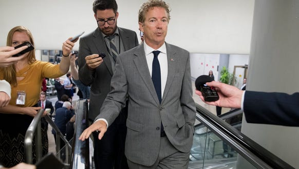 Sen. Rand Paul and members of the news media are pictured
