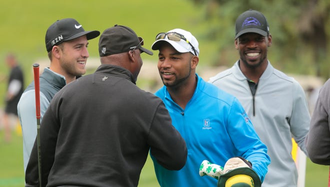 Detroit Lions head coach Jim Caldwell (foreground, left) talks with wide receiver Golden Tate as punter Sam Martin (left) and cornerback Rashean Mathis look on before the Charlie Sanders Foundation Golf Outing at Knollwood Country Club in West Bloomfield on June 1, 2015.