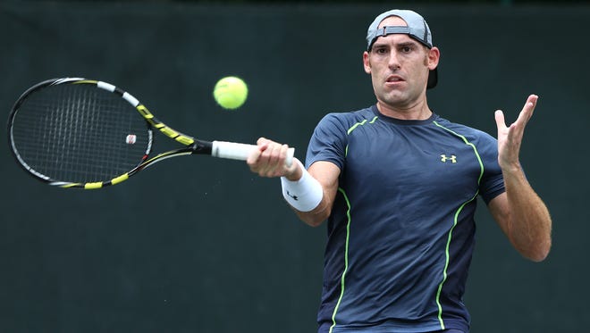 FILE -- Robby Ginepri returns the ball against Joel Kielbowicz, not pictured, during the Pearson Ford Open tennis tournament at Woodstock Club, Sunday, June 21, 2015.  Ginepri won the match in two sets.