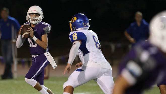 Shasta quarterback Ian Garcia (left) attempts a pass during the Wolves' season opener, a 30-18 win over Anderson.