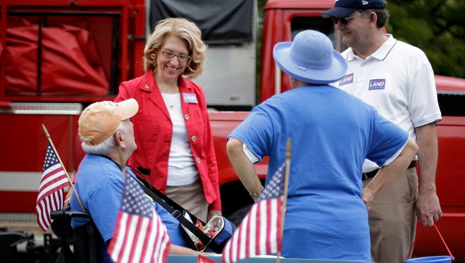 
Terri Lynn Land, Republican candidate for U.S. Senate, talks with a participant before the Labor Day Parade in Romeo on Sept. 1. 

