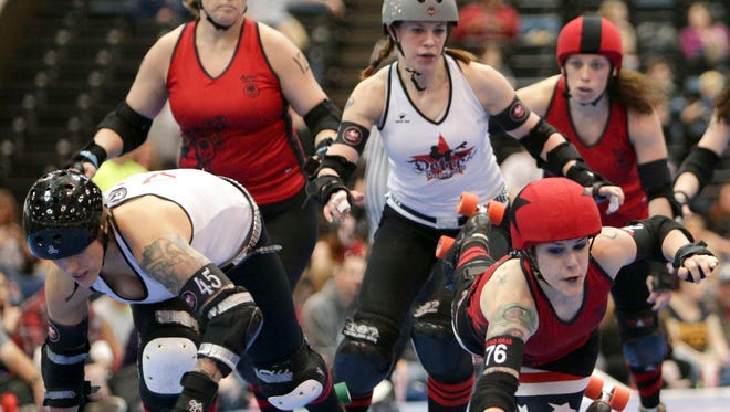 "Maiden America," a skater with the Naptown Roller Girls, hits the track after being blocked by Detroit Derby Girls during a roller derby game at the Indiana Convention Center on April 5, 2013.