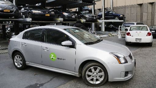 A Zipcar is parked at a lot in New York. The carsharing service, now owned by Avis Budget Group, has vehicles in 31 metro areas across seven countries and more than 400 college campuses.