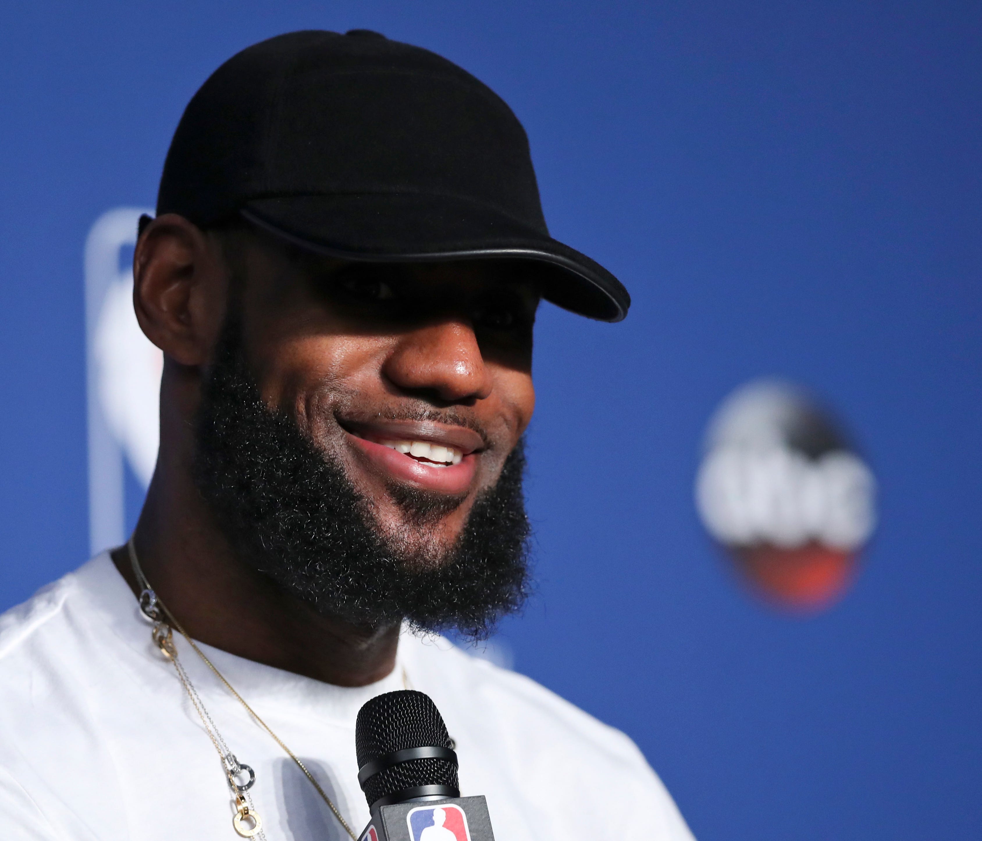 Cleveland Cavaliers forward LeBron James smiles during a news conference following Game 4 of basketball's NBA Finals against the Golden State Warriors, early Saturday, June 9, 2018, in Cleveland. The Warriors defeated the Cavaliers 108-85 to sweep th