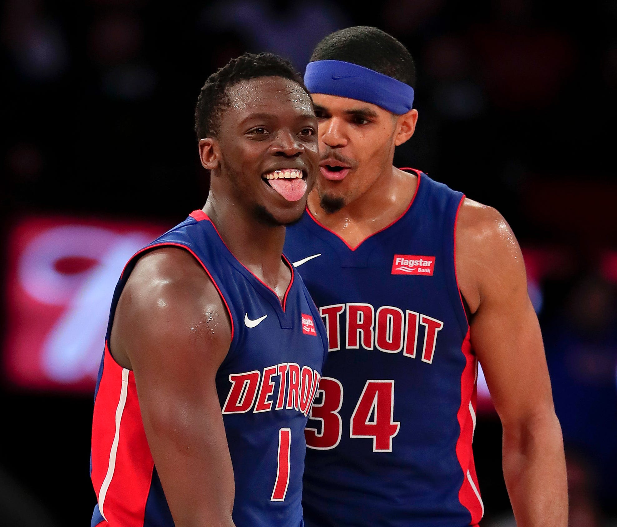 Detroit Pistons guard Reggie Jackson (1) and forward Tobias Harris (34) react after Jackson scored against the New York Knicks during the fourth quarter.
