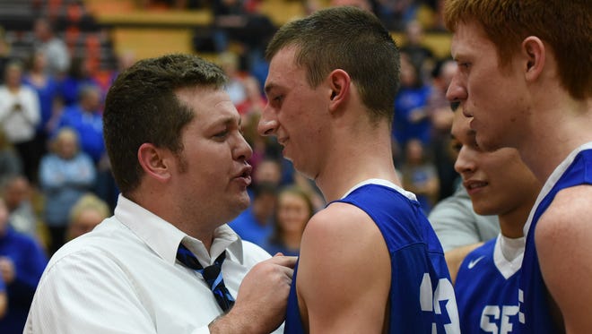 Southeastern head coach Andy Slaughter congratulates senior Ethan Smith after the Panthers knocked off top-seeded Lynchburg-Clay, 65-62, Feb. 24 in a Division III sectional championship.