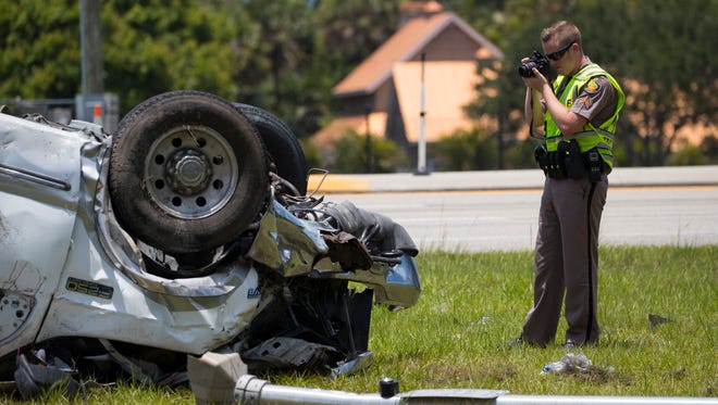 A Florida Highway Patrol trooper photographs the scene of a fatal vehicle crash at the intersection of Michael G. Rippe Parkway and Briarcliff Road Monday, May 22, 2017.