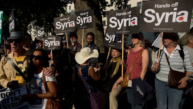 People take part in a protest in London on Wednesday calling for no military attack on Syria from the U.S., Britain or France.