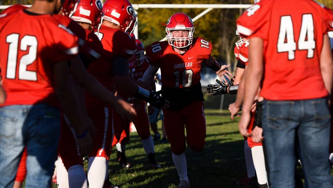 Gregory quarterback Andy McCance (10) runs through a tunnel of teammates during introductions before the first half of their high school football game on Friday, Oct. 19, 2017 in Gregory. 