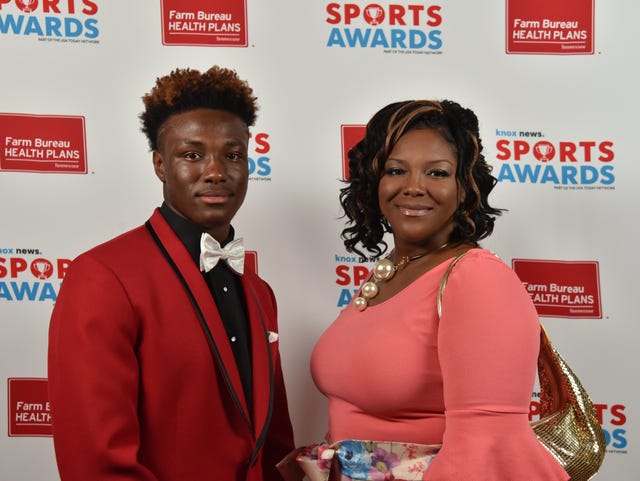 Fulton High School state champion wrestler Elijah Davis, left, poses for photo Thursday with his mother, Tynesha Davis, before the Knox News Sports Awards ceremony at the Tennessee Theatre.