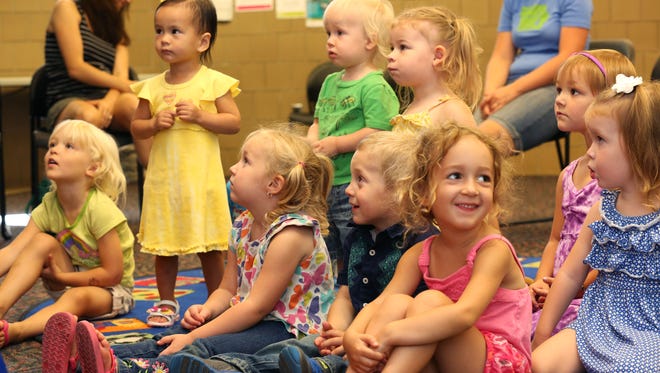 Children attend Toddler Storytime at the South Side Library on Wednesday, Aug. 13, 2014. The program is for children ages 18 months to three-years-old every Wednesday at 10 a.m. Toddlers (and caregivers) participate in stories, songs, finger plays and rhymes. Pictured are front row l-r: Harper Noble, 3, of Des Moines' south side; Ella Pattengill, 3, and Cameron Pattengill, 2, both from Des Moines' south side, and Stella Heathcote, 4, of Des Moines' south side. Back row: Madeline Le, 22 mos., of Des Moines' southwest side; Oliver Couture, 1, of Clive; Evelyn Warywoda, 3, of Des Moines' south side; Zoe Saunders, 3, of Des Moines' Easter Lake neighborhood, and Avery Marr, 2, of West Des Moines. Some cropping may occur in digital versions.