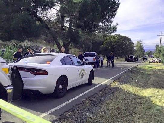 Law enforcement officials investigate a portion of