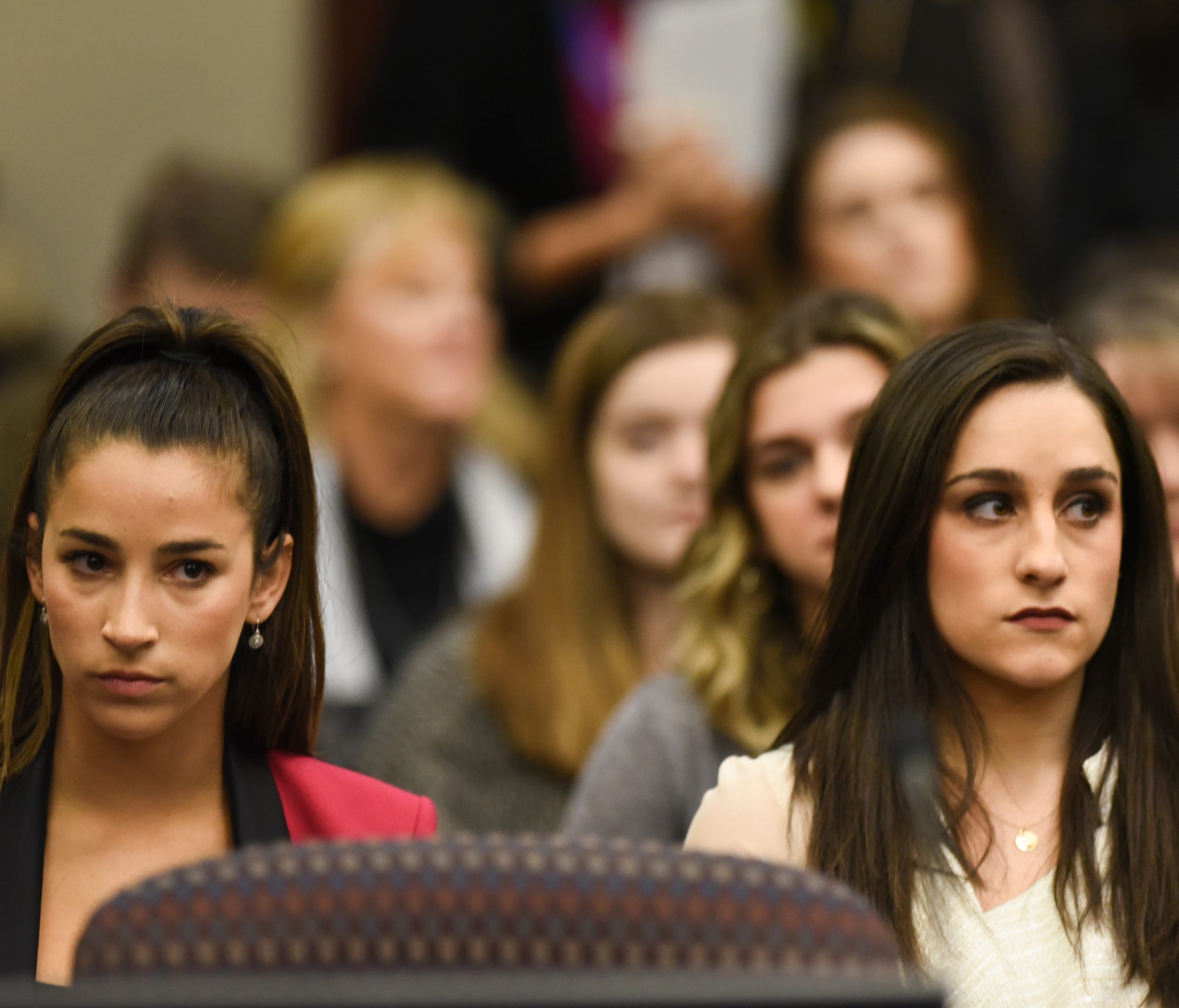 Olympic gold medalists Aly Raisman, left, and Jordyn Wieber sit in Circuit Judge Rosemarie Aquilina's courtroom Friday, Jan. 19, 2018, during the fourth day the sentencing hearing for former sports medicine doctor Larry Nassar, who pleaded guilty to 