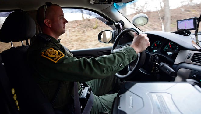 Justin Ritter drives along the roads near State Game Lands 416 on Tuesday, March 6, 2018. Ritter, a game warden, said he knows his job is dangerous but he loves it anyway.