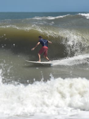 James Loehr, of Fort Pierce, rides in the tube of rough waves as swells from Hurricane Maria kick up the surf at Fort Pierce Inlet State Park on Monday, Sept. 25, in Fort Pierce. “ "It's been messy, the northeast winds, I think tomorrow its supposed to get better, (winds) to be offshore from the southwest, I think tomorrow will be the day," Loehr said. "It's good out there, better than it was in July."