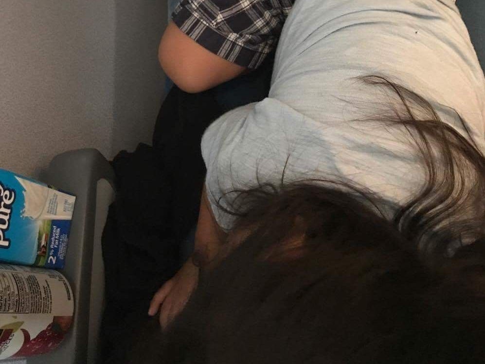 The boy lies on the floor.