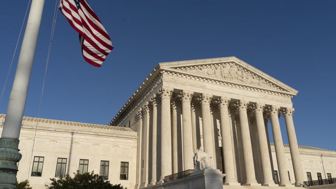 In this April 20, 2018 file photo, the Supreme Court is seen in Washington. The Supreme Court is setting aside a Colorado court ruling against a baker who wouldnât make a wedding cake for a same-sex couple. But the court is not deciding the big issue in the case, whether a business can refuse to serve gay and lesbian people. (AP Photo/J. Scott Applewhite)
