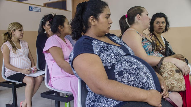 Women on Friday wait their turn for their pre-natal exams at the National Hospital for Women in San Salvador, El Salvador. In the Central American nation authorities have urged women to put off pregnancy for two years after it was reported that there may be a possible link between mosquito-borne Zika and microcephaly, in which infants are born with unusually small heads and can sometimes suffer mental retardation or a host of serious health and developmental problems.