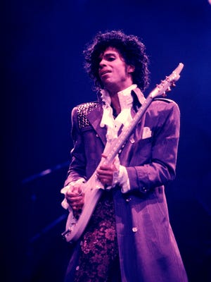Prince performing on stage during the Purple Rain Tour in 1984.