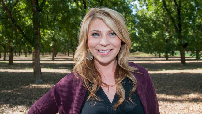 Heather Salopek stands in some of her family's 3,000 acres of pecan orchards. Her company, Legacy Pecans, packages pecans in 10 different flavors as well as 8 different types of pecan-flavored coffees amongst other items.