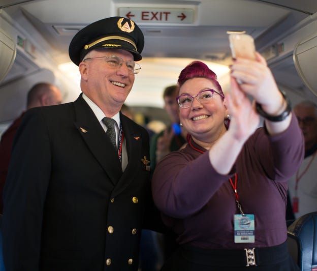 Delta Air Lines Capt. Paul Gallaher and Delta employee Jennifer Price take a selfie together on the upper deck of the Boeing 747 during the first leg of Delta Air Lines' Boeing 747-400 farewell retirement tour on Dec. 18, 2017.