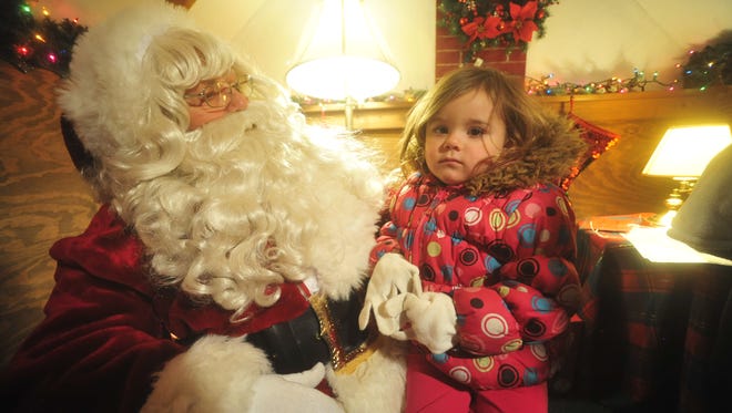 Two-year-old Aryah Case, of Bucyrus, tells Santa on Friday what she'd like for Christmas.