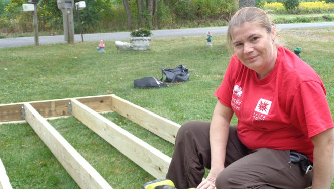 Larese Isaacson, a client of Fairview Recovery Services, volunteers for the Broome County Council of Churches' Ramp It Up program.