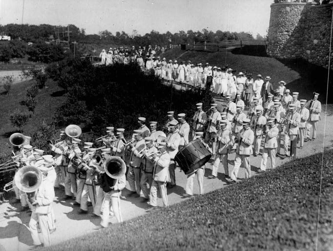 Led by the white and gold uniformed Park Band, a group