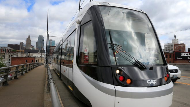 In this Wednesday, April 27, 2016 photo, a streetcar takes a practice run along Main Street in Kansas City, Mo. A city that once had one of the nations largest streetcar networks is preparing to launch smaller, modern version that supporters say will shape development for years to come. Kansas City is celebrating the opening of its 2.2-mile streetcar line on Friday, May 6, 2016, with street parties, speeches and fireworks. (AP Photo/Orlin Wagner)