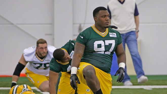 Green Bay Packers rookie Kenny Clark stretches during practice under the eyes of Packers general manager Ted Thompson during rookie camp in the Don Hutson Center May 6,  2016. 