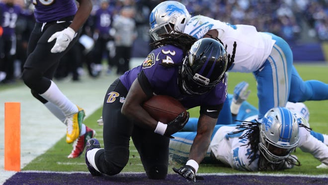 Ravens running back Alex Collins rushes for a touchdown in the fourth quarter against the Lions at M&T Bank Stadium on Sunday, Dec. 3, 2017 in Baltimore, Md.