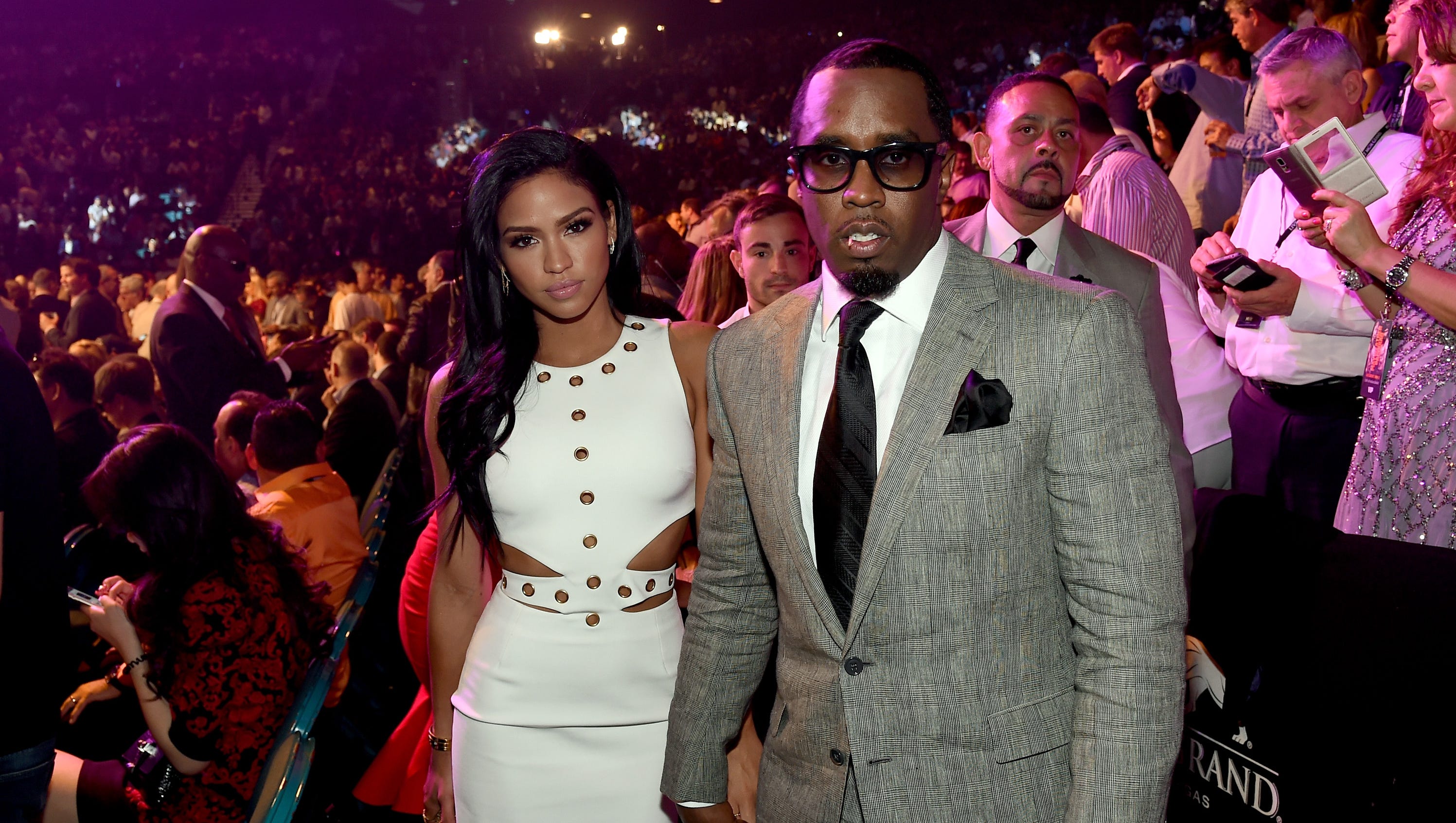 Sean "Diddy" Combs poses ringside with model Cassie Ventura.