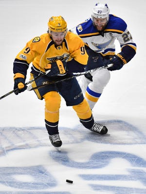 Nashville Predators left wing Filip Forsberg (9) and St. Louis Blues defenseman Alex Pietrangelo (27) battle for a puck during the first period in game 4 of the second round NHL Stanley Cup Playoffs at the Bridgestone Arena Tuesday, May 2, 2017, in Nashville, Tenn.