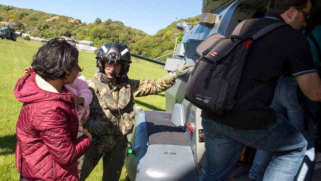 In this image provided by the Royal New Zealand Defense Force, tourists are evacuated by helicopter from Kaikoura following Monday's earthquake, in New Zealand, Tuesday, Nov. 15, 2016. New Zealand military officials said Tuesday that they had evacuated about 140 people by helicopter from a coastal town and were expecting that number to rise to 200 by the end of the day, as a major rescue operation unfolded following a powerful earthquake.